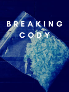 An enlarged image of a small plastic ziplock bag of blue crystal meth on a sapphire blue background. Breaking Cody, the title of the film is top center in bold white text.