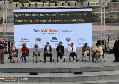 Q&A of ReelAbilities International Shorts Panel. Participating panelists are seated on stage, including the MC Nikki Bailey, and ASL interpreters on both sides of the stage.