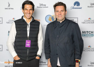 Photo of Matt Wiener and another festival attendee posing in front of the step and repeat. Both facing the camera.