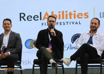ReelAbilities Q&A of ReelAbilities International Shorts Panel. Order of appearance left to right, Jose Navas, and Ryan Mack is talking holding the microphone ,and Eyal Resh is to his right.